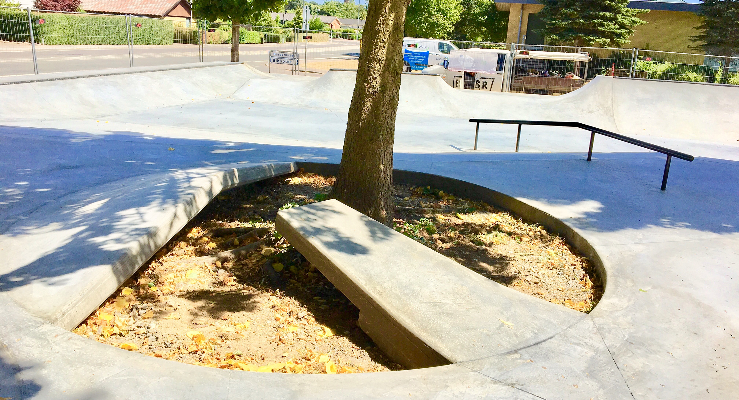 Billedet viser en lille rampe i beton støbt op ad et træ
