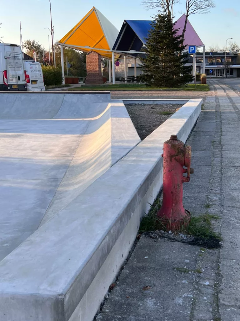 Lav bank i beton in situ støbt op ad brandhane i Tarm Skatepark
